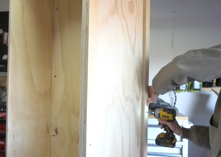 Screw spacer blocks onto cabinet sides