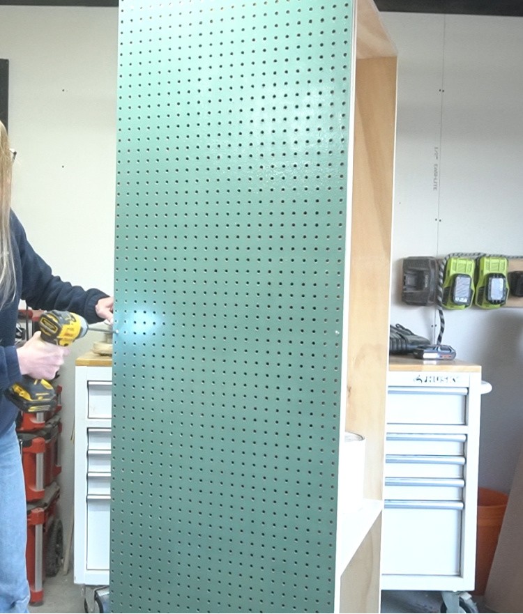 Install peg board panel onto side of cabinet onto spacer blocks