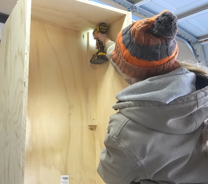 Installing the scrap spacer blocks into the cabinet