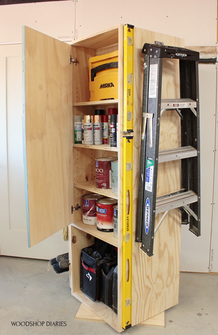 Garage cabinet with door open--storing paint cans inside