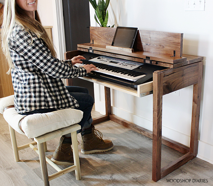 Shara Woodshop Diaries playing keyboard at flip top keyboard stand