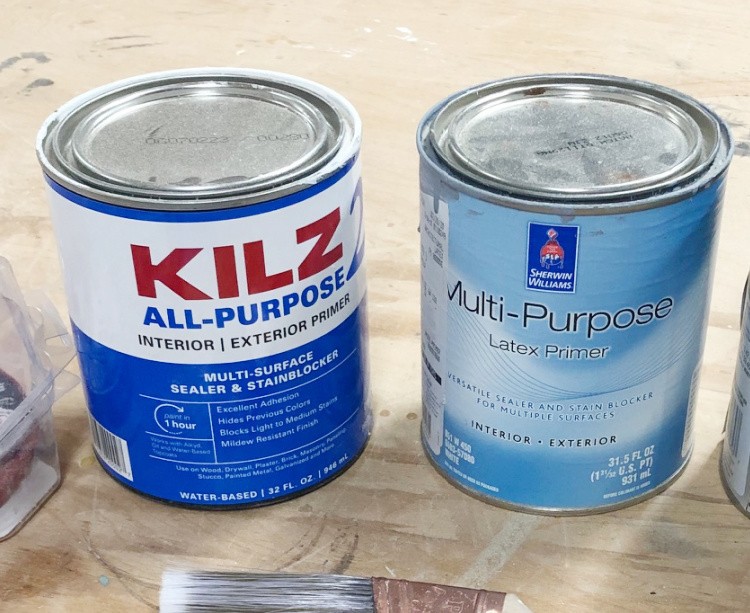 Close up of two primer cans--one Kilz 2 and the other Sherwin Williams Multi-Purpose