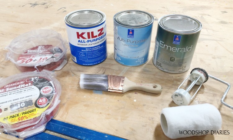 Materials needed to paint raw wood furniture--primer, paint, roller, brush, and sandpaper