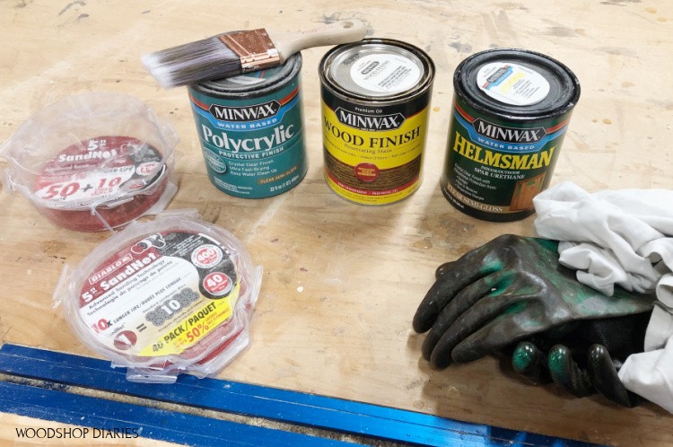 Materials needed to stain wood--stain, rag, gloves, sandpaper, brush, clear coat poly