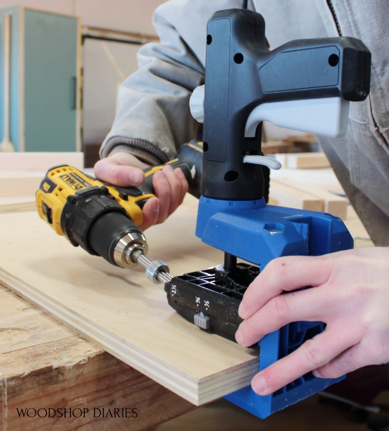 Shara Woodshop Diaries drilling pocket hole into plywood panel using the Kreg 520 jig