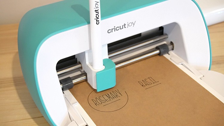 Close up of Cricut Joy drawing name stickers on writable paper