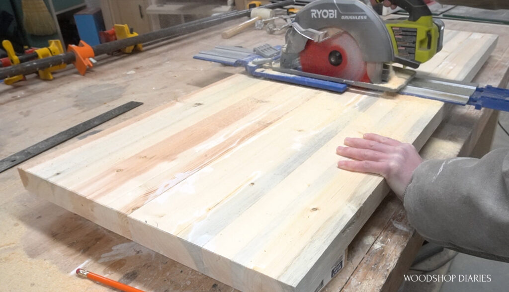 Shara using circular saw and AccuCut to trim shelf panel from slab