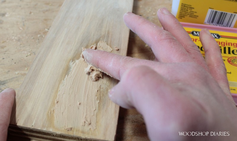 Applying second coat of wood putty to fill pocket hole