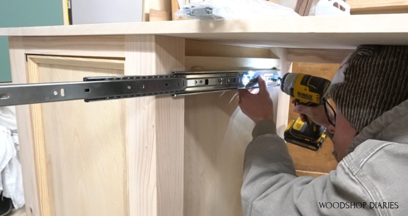 Shara Woodshop Diaries installing drawer slides into center of desk