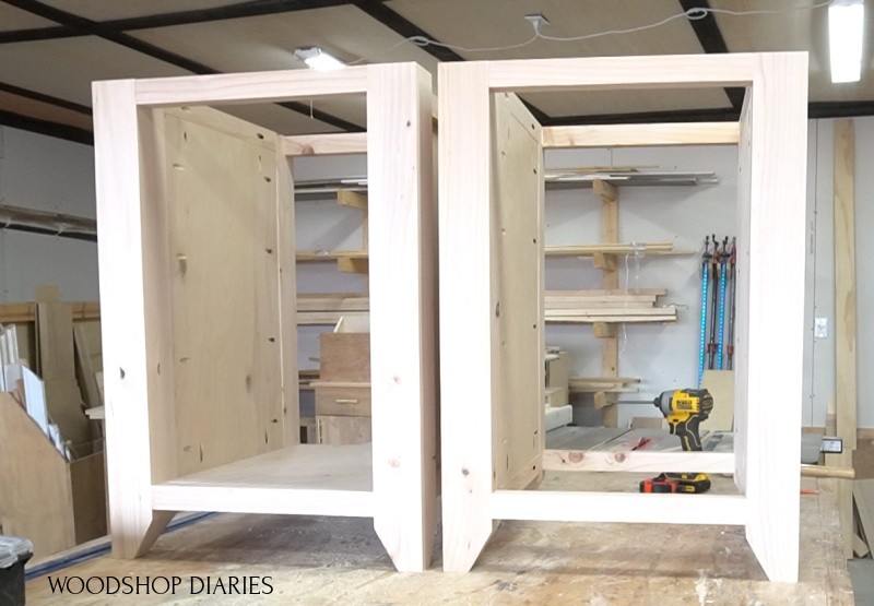 Left and right desk cabinets assembled on workbench--left cabinet with solid bottom and right cabinet with open bottom