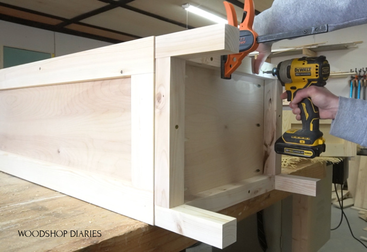 using screws to attach base frame to tall pantry cabinet box