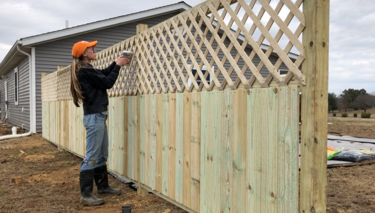 Stapling lattice panels onto back side of privacy fence