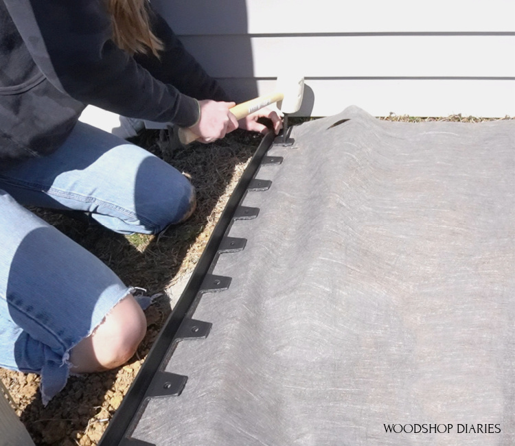 Using rubber stakes to secure no dig edging around outside of landscape garden area