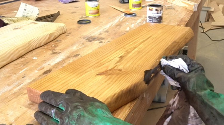 Applying dark Kona stain to DIY faux live edges to highlight fake bark