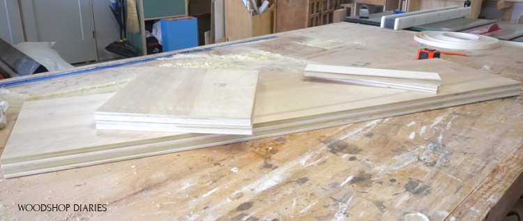 plywood pieces laid out on workbench to build linen cabinet carcass