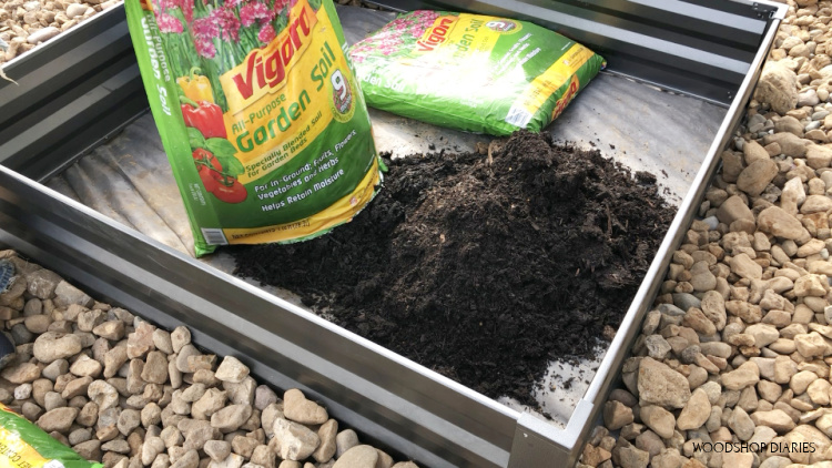 Pouring bags of garden soil into raised garden beds of garden patio makeover