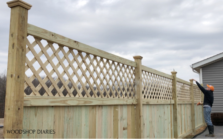 Shara Woodshop Diaries gluing fence post caps on top of privacy fence posts