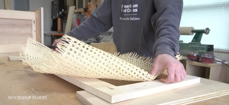 test fitting a roll of cane webbing onto linen cabinet door