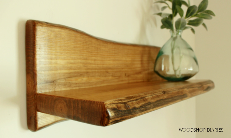 Close up of corner of DIY faux live edge shelf where the wire brush made indentions