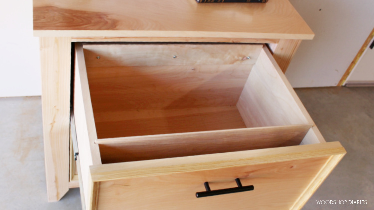 File cabinet drawer open showing locations of plywood file folder rails