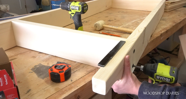 Using a speed square to keep pieces in place while driving screws