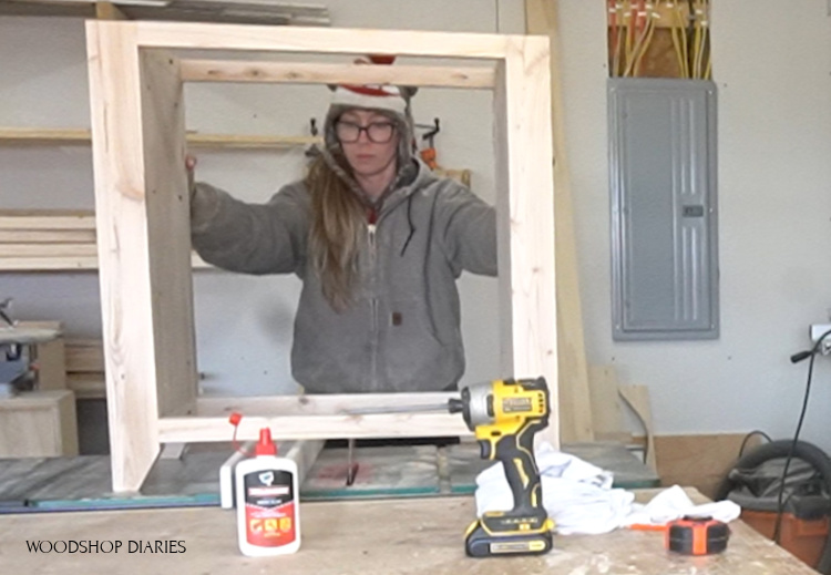 Shara setting cabinet frame on table saw to check for wobble