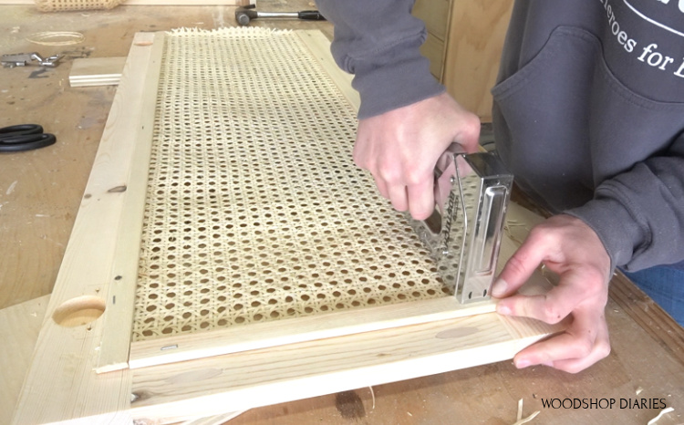 stapling thin trim pieces around cane edges on back side of cabinet door