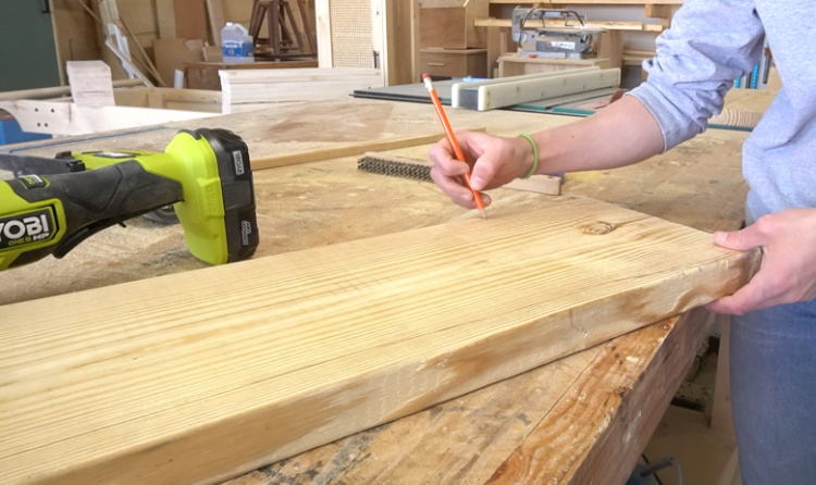 Shara Woodshop Diaries tracing DIY faux live edge onto back panel of floating shelf