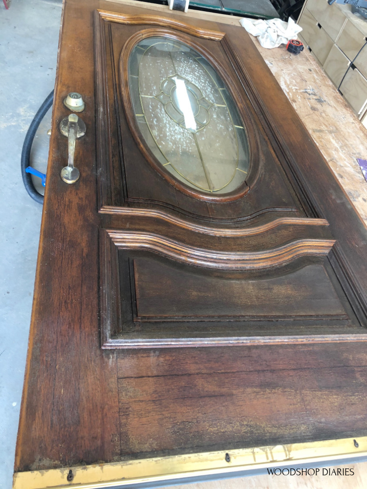 Old front door laid on workbench