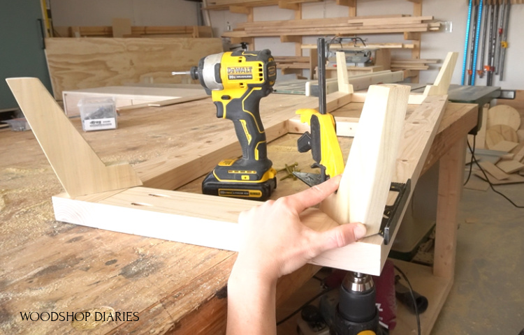 Shara Woodshop Diaries installing legs onto base of dresser