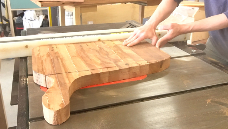 Cutting off handle on cutting board using table saw 