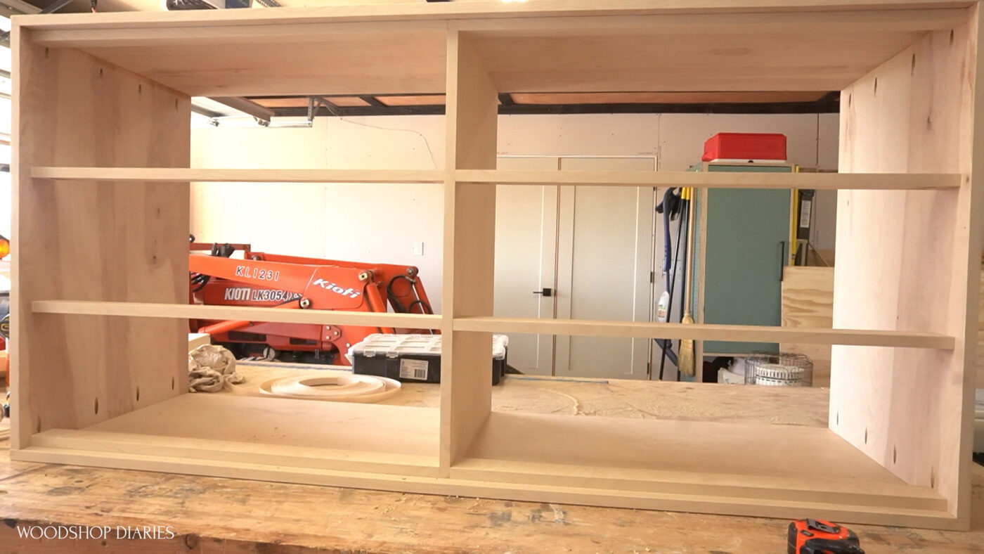 Dresser body assembled with dividers sitting on workbench ready for slides