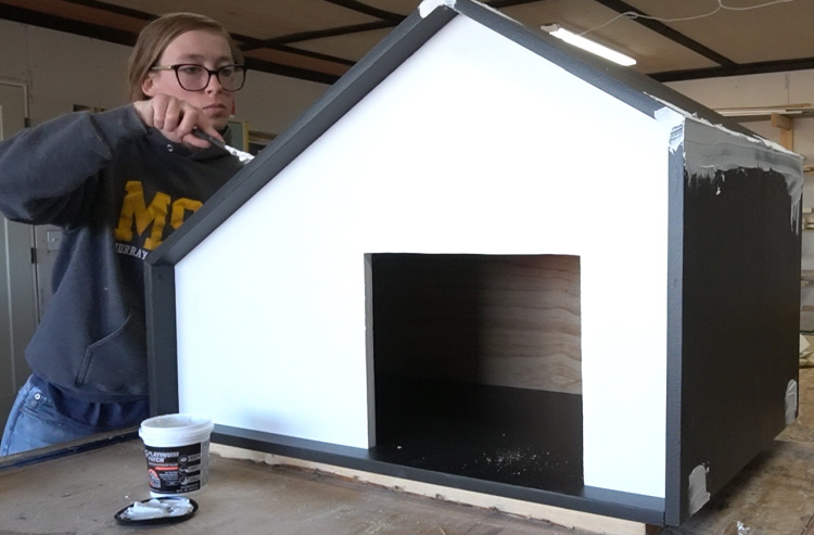 Shara Woodshop Diaries using DAP Platinum Patch filler to seal seams and screw heads on DIY outdoor dog house