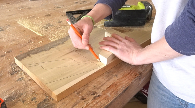 Shara Woodshop Diaries tracing leg shape onto poplar board to cut out