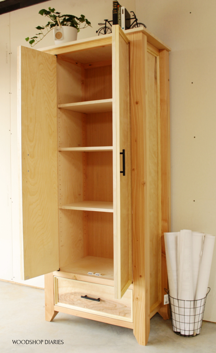 Finished and completed DIY armoire wardrobe cabinet with doors open and shelves installed