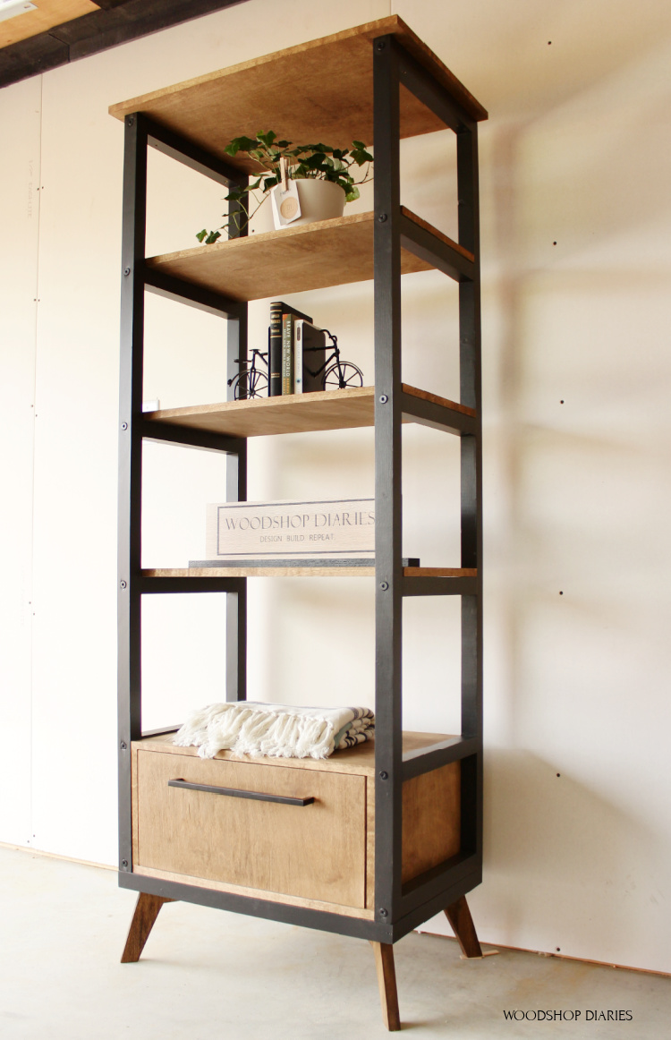 Finished open bookshelf black and wood with drawer at bottom and mid century modern legs