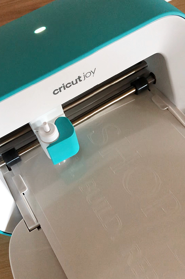 Cricut Joy cutting vinyl stencil to make wooden sign