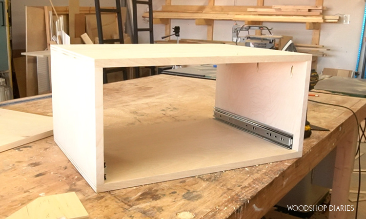 Drawer cabinet box on workbench with drawer slides installed