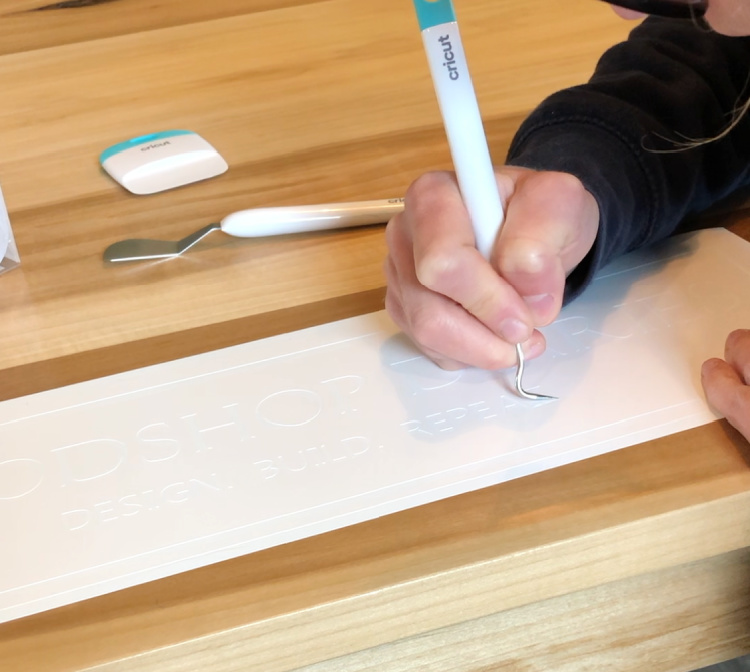 Using picker tool to remove lettering from vinyl stencil