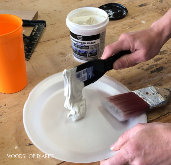 Scooping out wood filler onto styrofoam plate