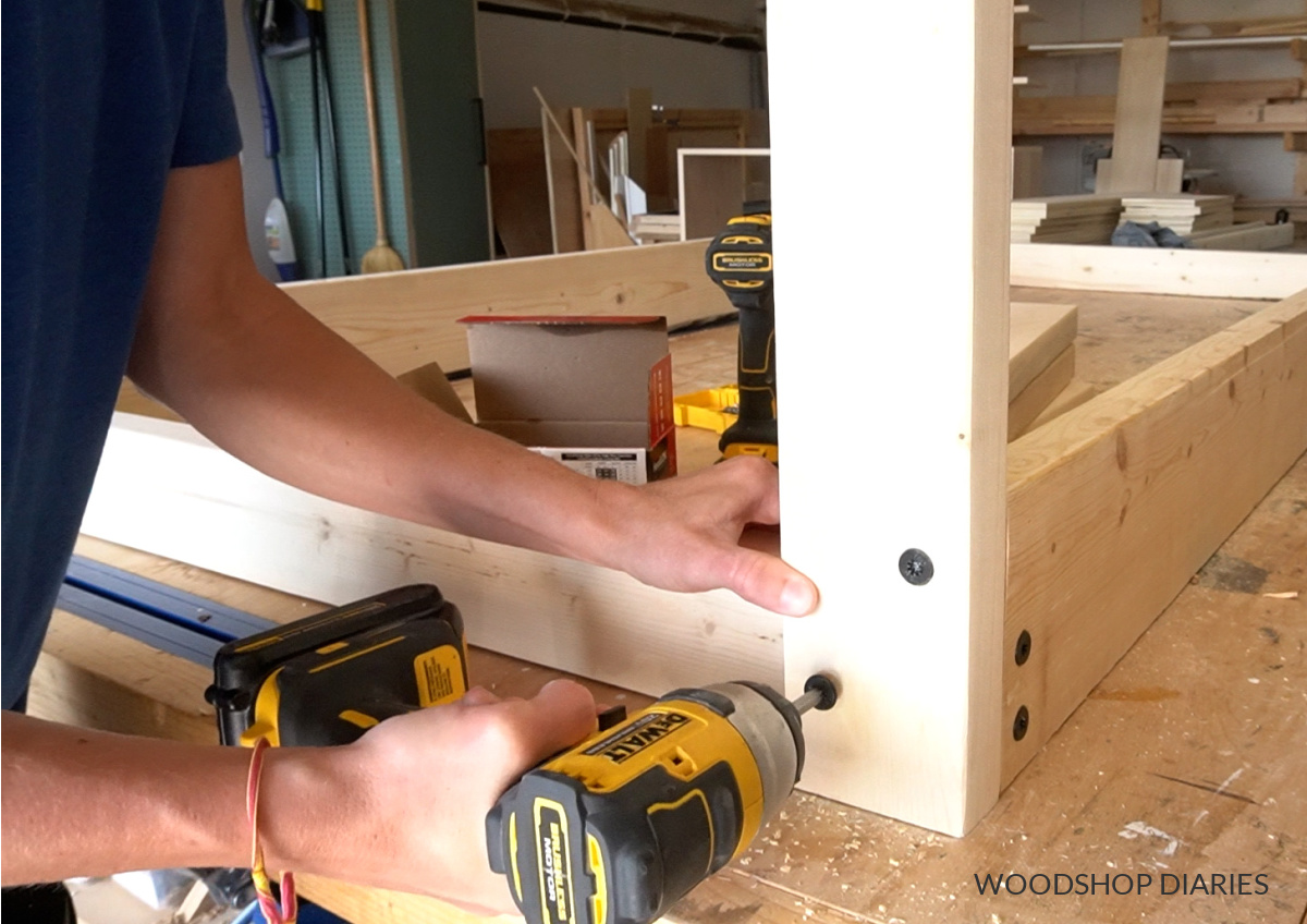 Close up of Shara Woodshop Diaries installing corner swing posts using timber screws