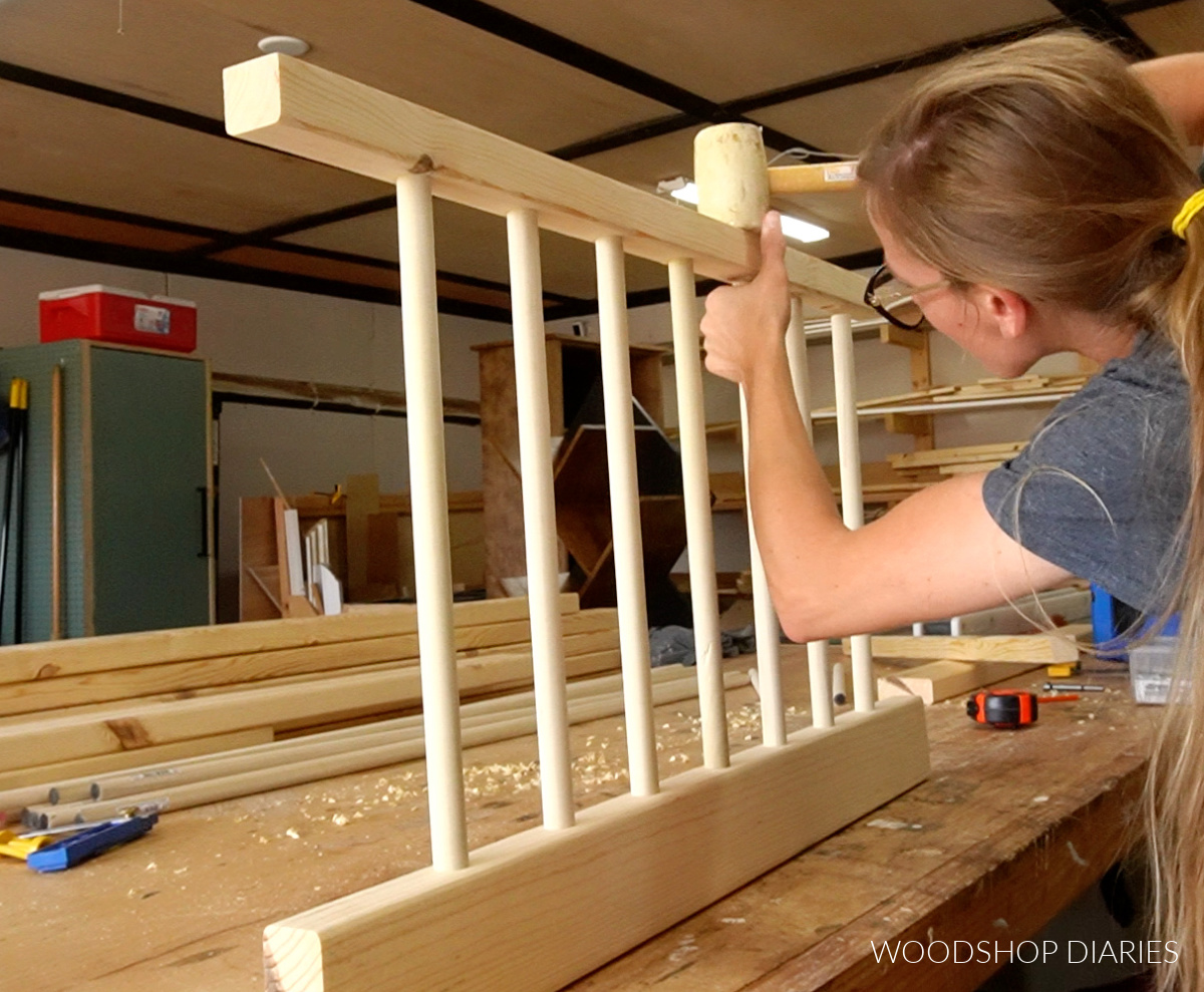 Shara Woodshop Diaries Assembling side rails of DIY toddler floor bed using a rubber mallet to tap dowels in place