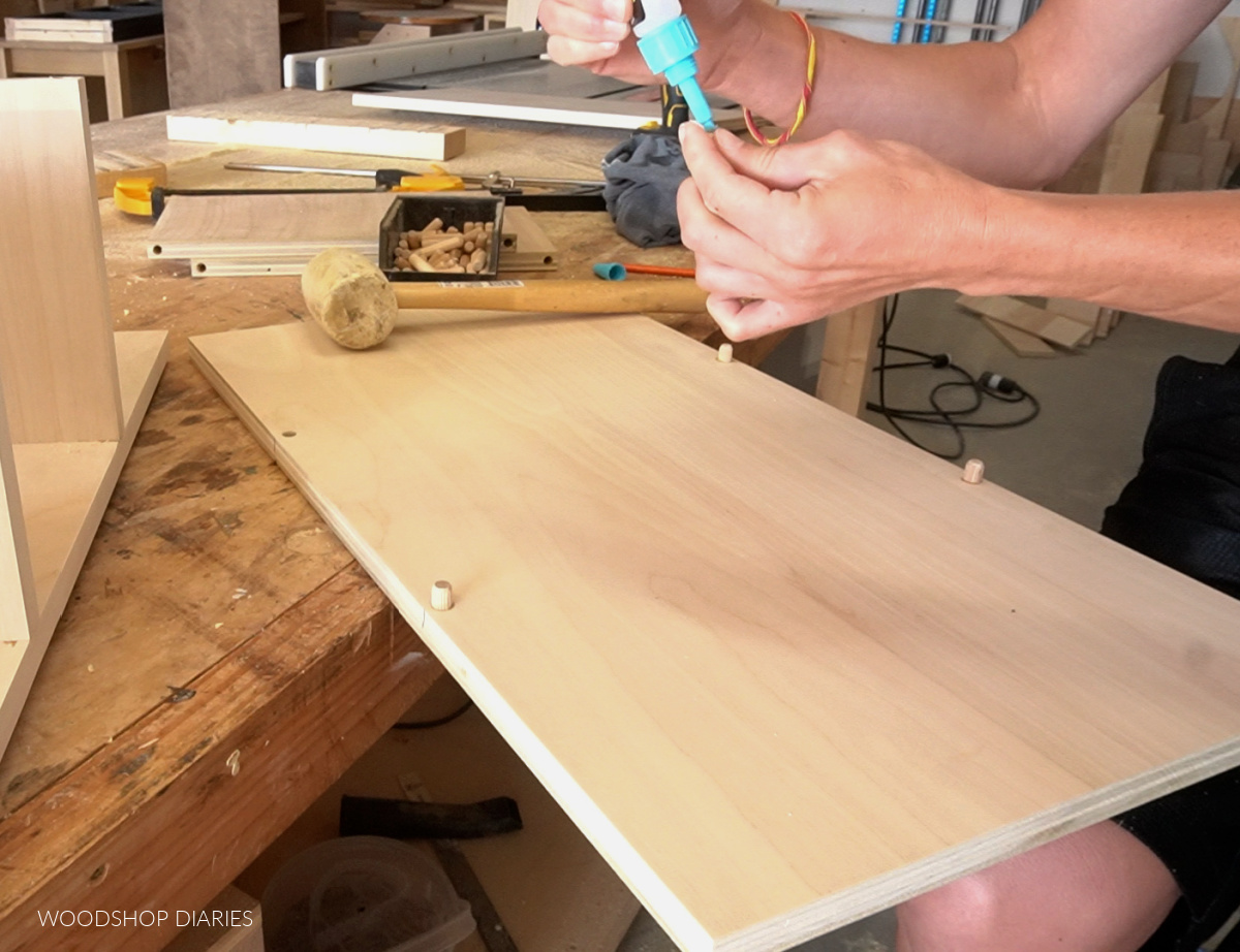 Shara Woodshop Diaries applying glue to install dowels