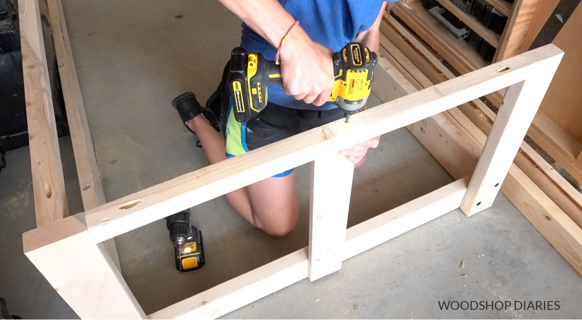 Shara Woodshop Diaries screwing slats in place on side of swing bed frame