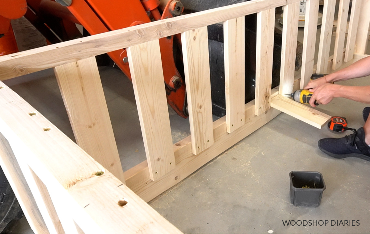 Shara Woodshop Diaries installing slats on back side of swing bed frame using spacer block