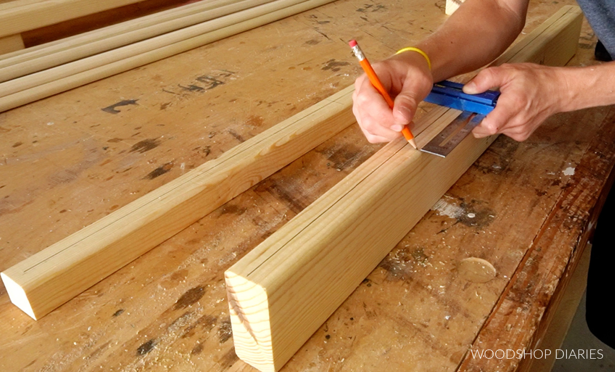 Shara Woodshop Diaries marking 4 ¼" offsets down length of board for toddler bed rail locations
