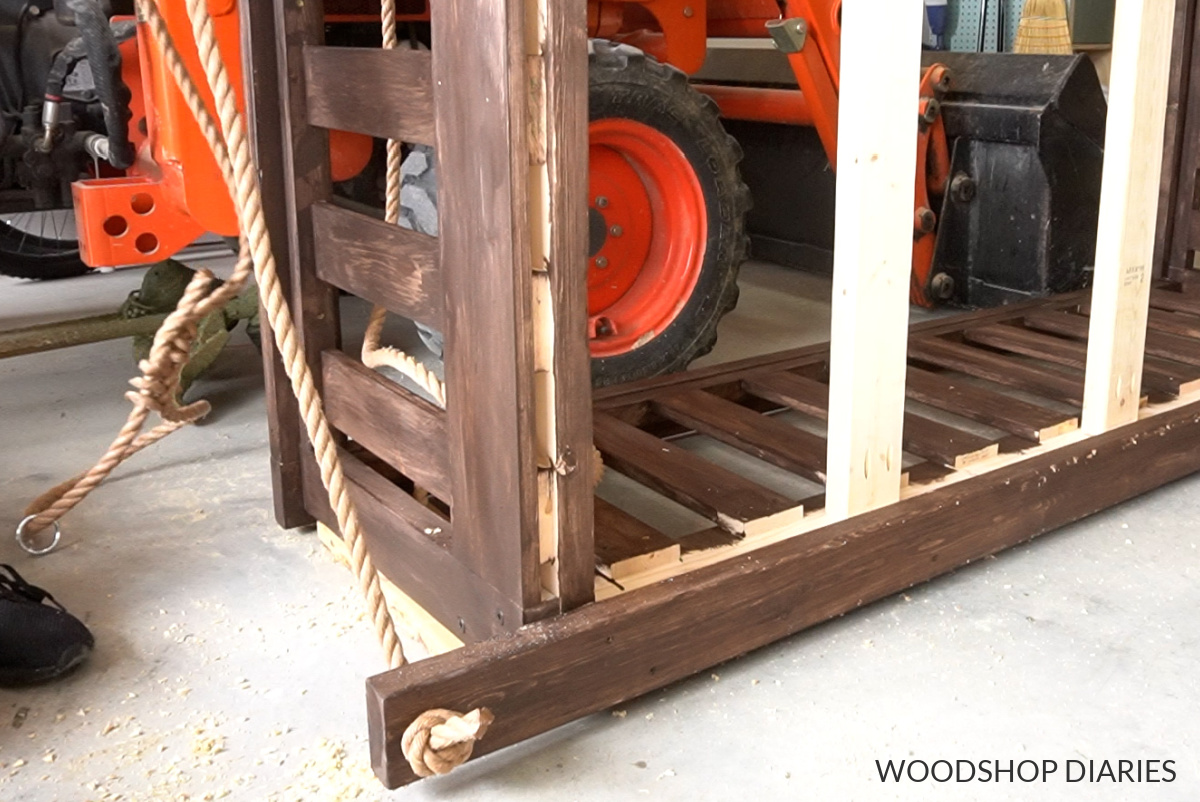 Close up of rope tied to corner of porch swing bed frame