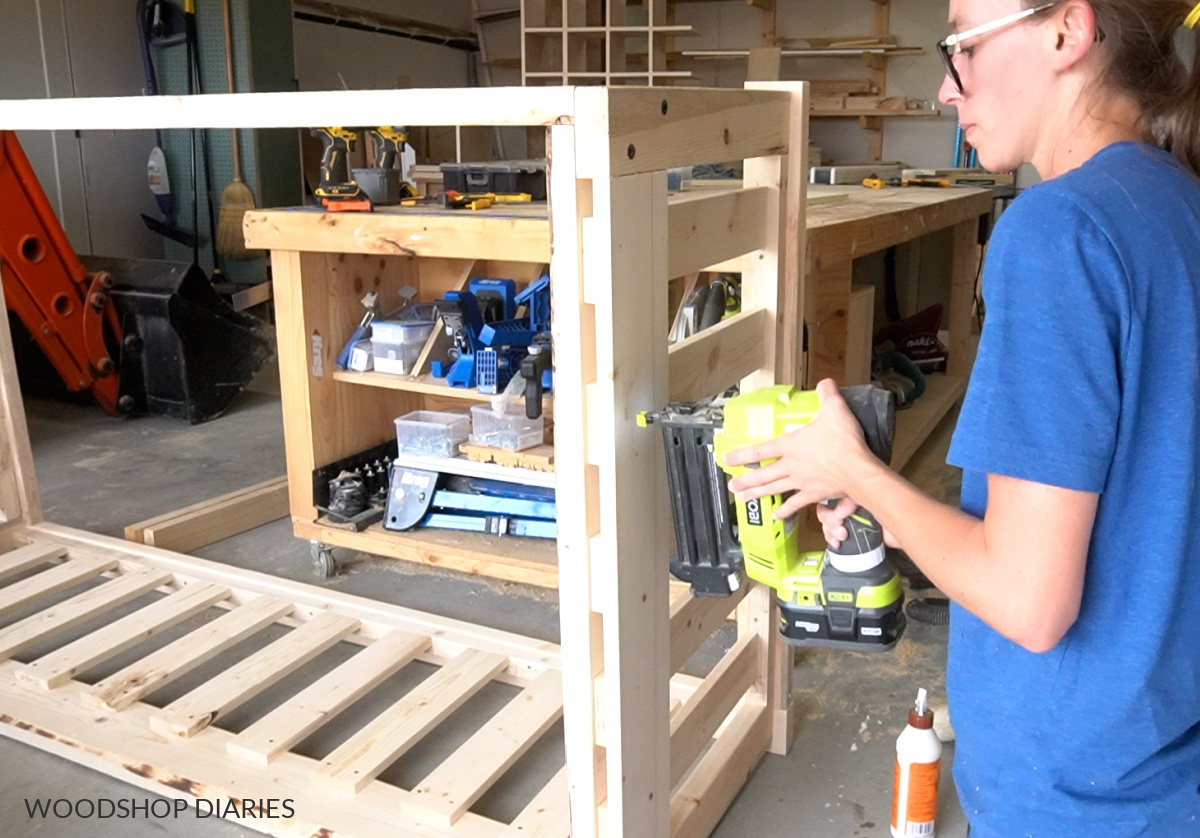 Shara Woodshop Diaries using a nail gun to install trim piece on side of swing frame