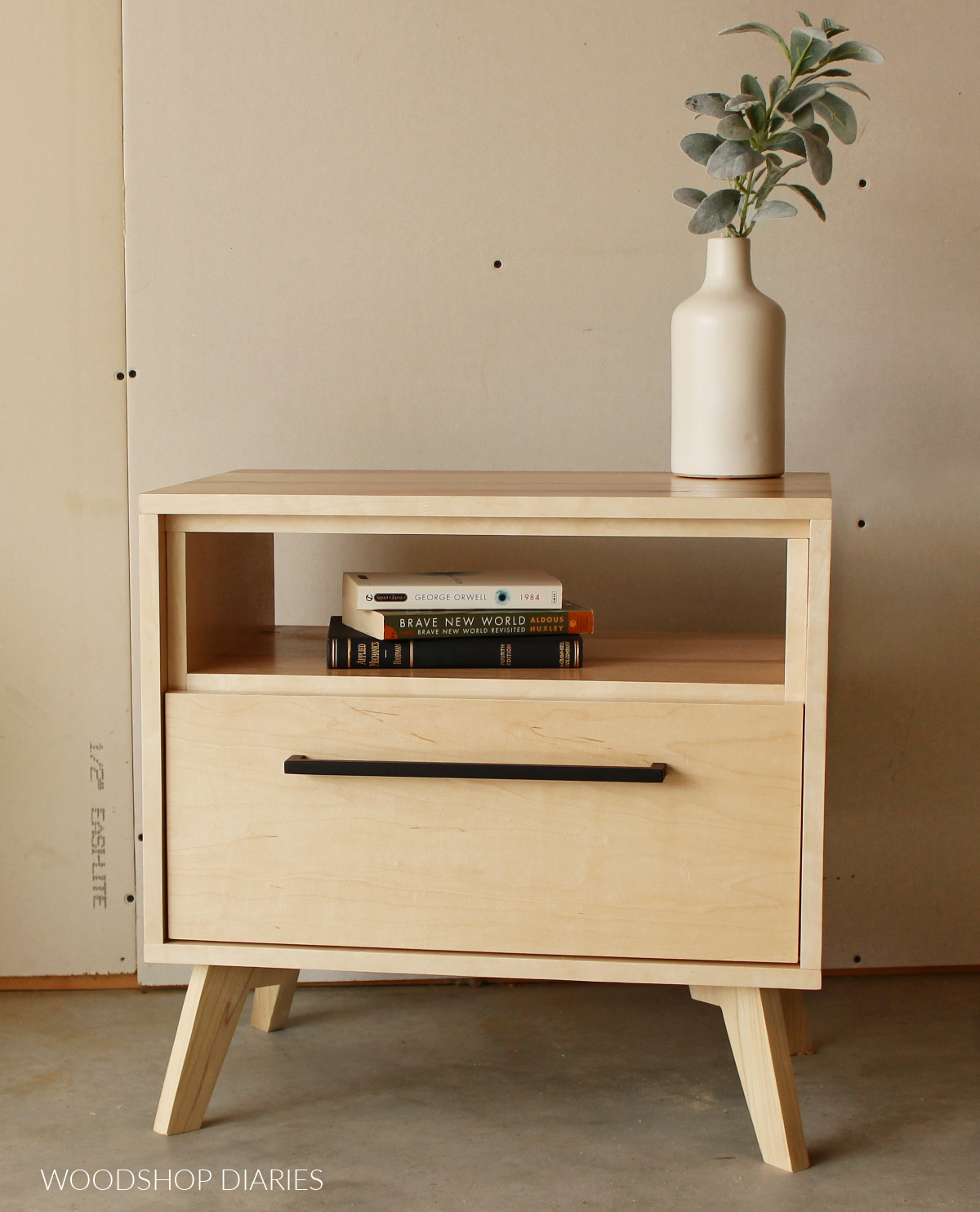 Finished nightstand--maple plywood finished with clear coat and a modern black handle on drawer.