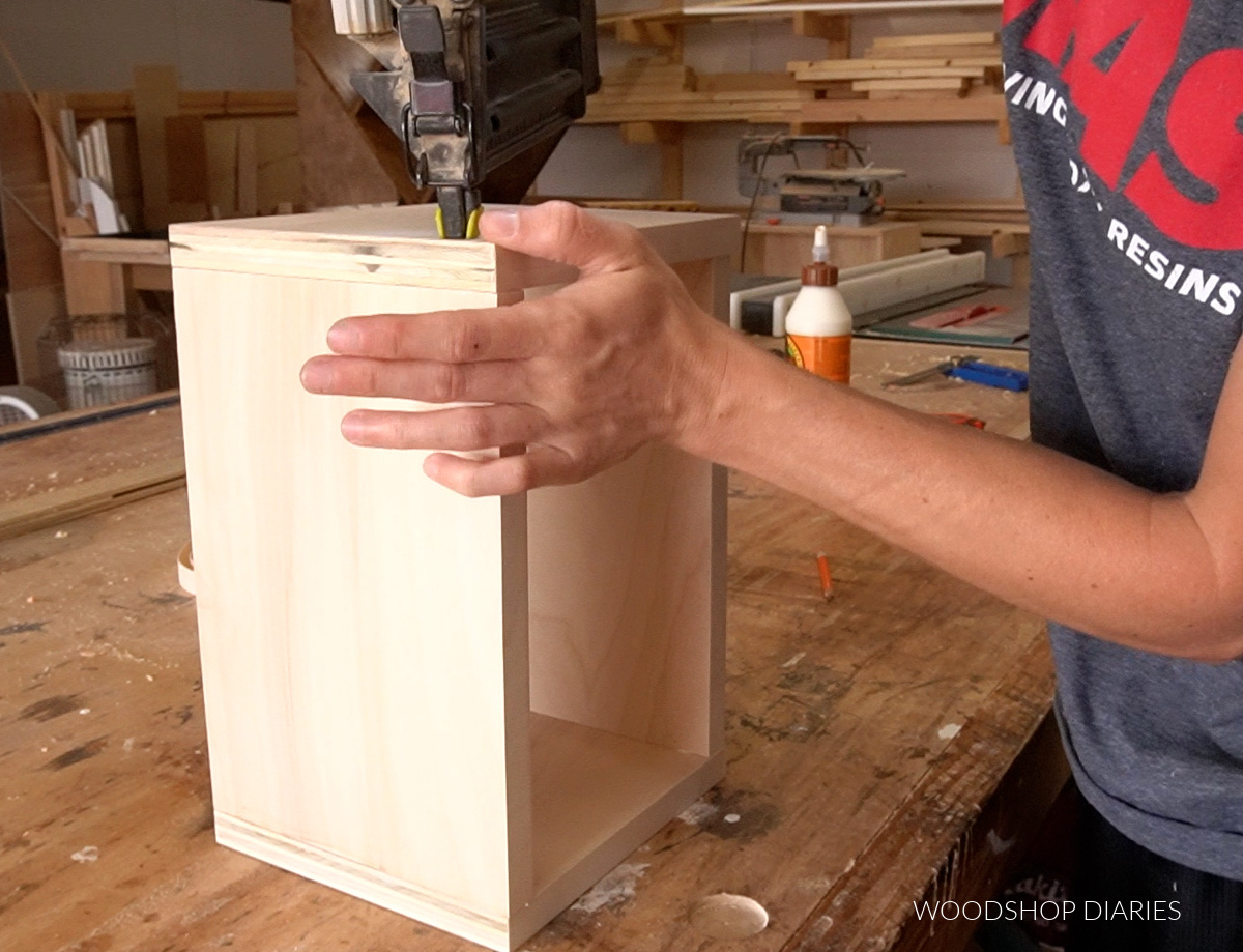 Shara using nail gun to glue and nail keepsake box together